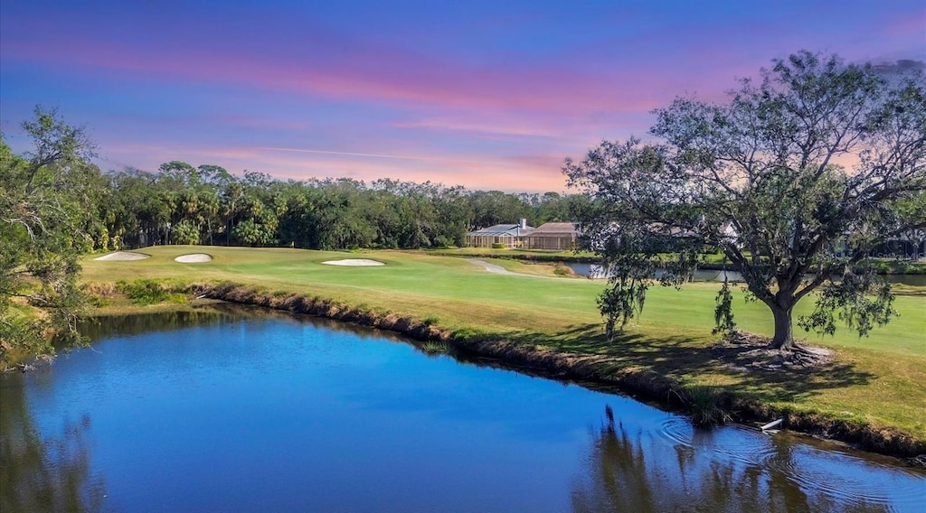 view of property's community featuring a yard and a water view