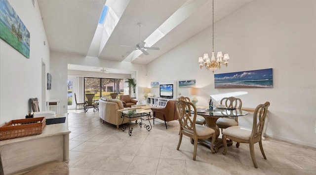 tiled dining space with ceiling fan with notable chandelier and high vaulted ceiling