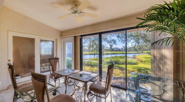 sunroom / solarium with ceiling fan, a water view, and lofted ceiling