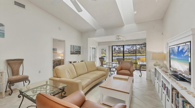 tiled living room featuring high vaulted ceiling and ceiling fan