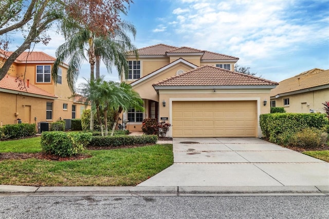 mediterranean / spanish-style house with a garage, central air condition unit, and a front yard