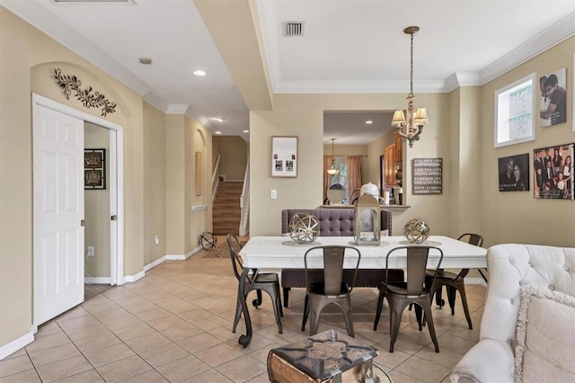 tiled dining space featuring ornamental molding and an inviting chandelier