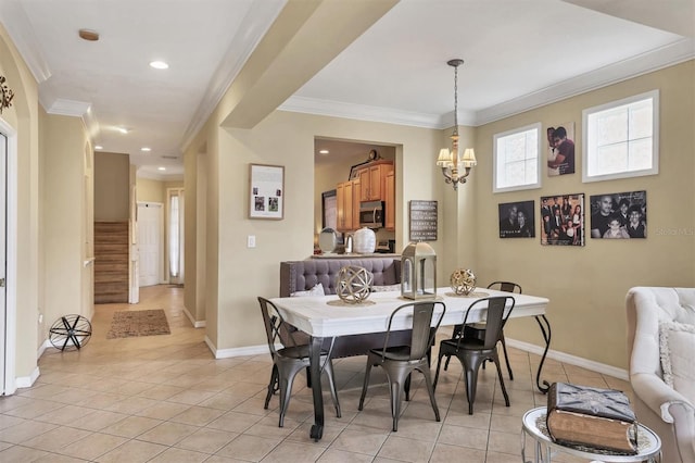 dining room with an inviting chandelier, light tile patterned flooring, and ornamental molding