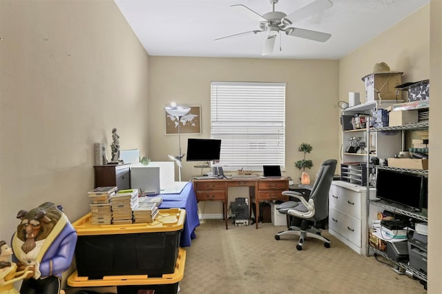 carpeted home office featuring ceiling fan