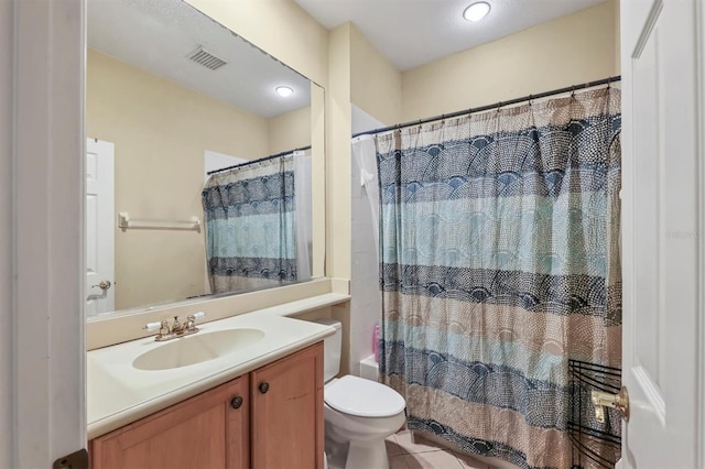 bathroom featuring tile patterned floors, vanity, and toilet