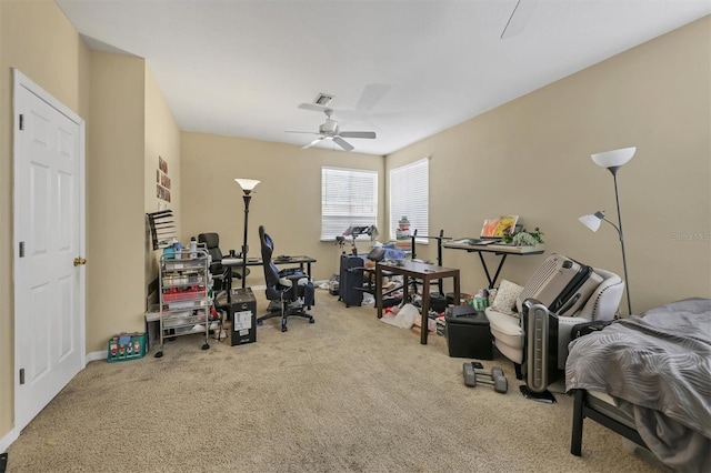 interior space with ceiling fan and light colored carpet