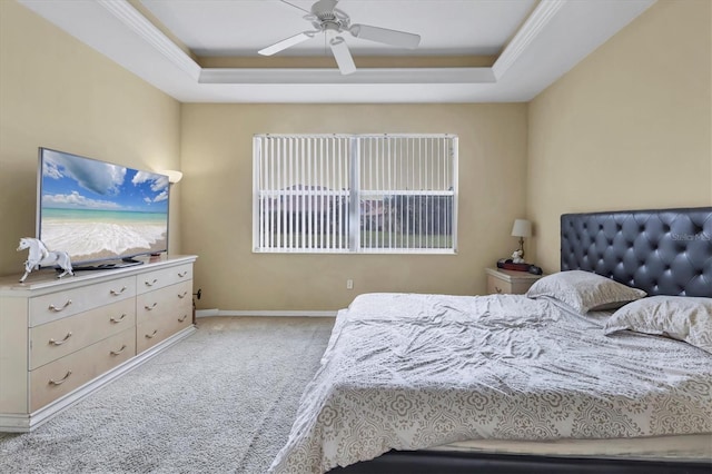 bedroom featuring a raised ceiling, ceiling fan, and light colored carpet