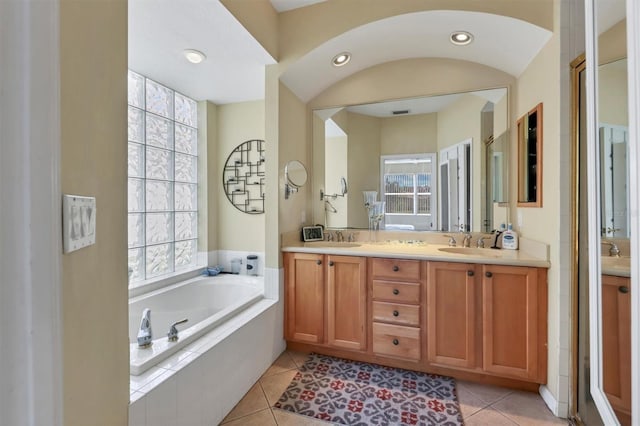 bathroom featuring tile patterned floors, vanity, and a wealth of natural light