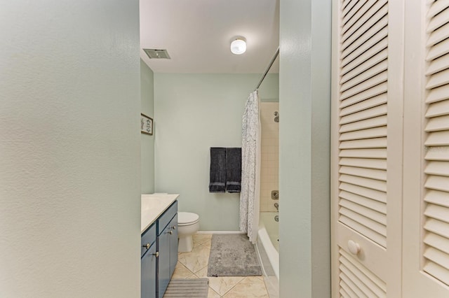 full bathroom with tile patterned flooring, vanity, toilet, and shower / bath combo with shower curtain