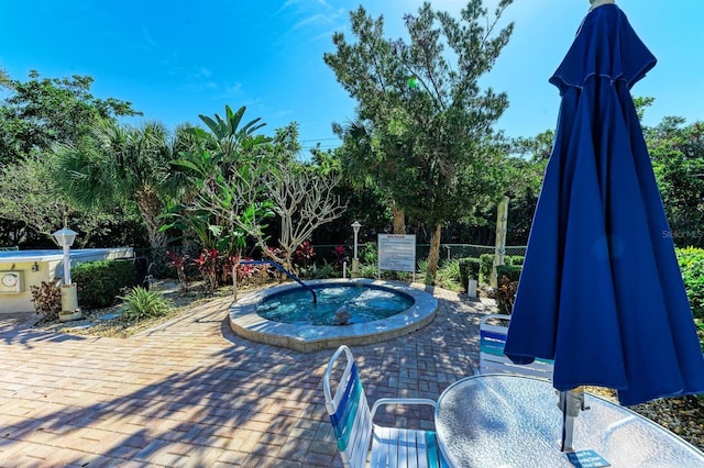 view of swimming pool featuring a community hot tub and a patio