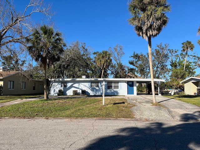 single story home with a front yard and a carport