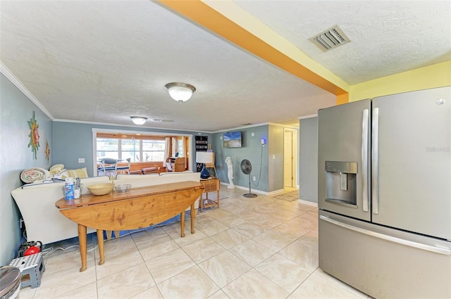 kitchen featuring stainless steel fridge, light tile patterned flooring, and ornamental molding