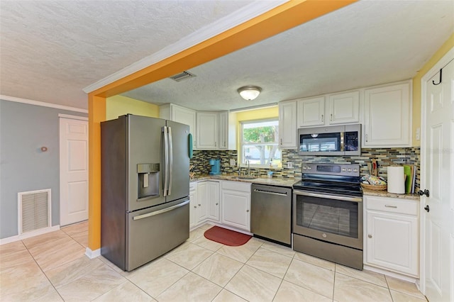 kitchen with white cabinetry, sink, tasteful backsplash, crown molding, and appliances with stainless steel finishes