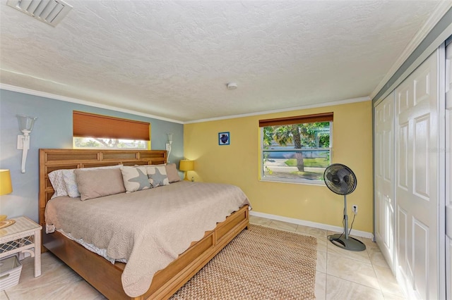 bedroom with a closet, ornamental molding, light tile patterned floors, and multiple windows