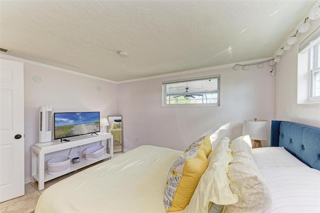 tiled bedroom featuring crown molding and a textured ceiling