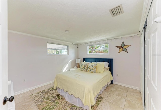 tiled bedroom featuring a textured ceiling