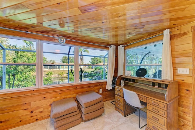 office featuring light tile patterned floors, plenty of natural light, wooden ceiling, and wood walls