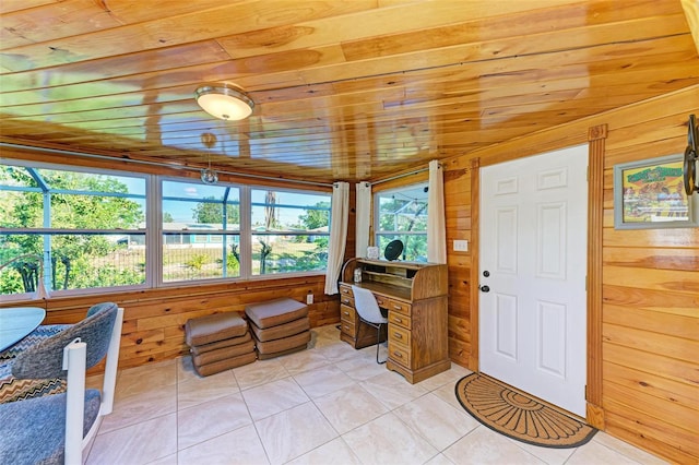 tiled home office featuring plenty of natural light, wooden ceiling, wooden walls, and vaulted ceiling