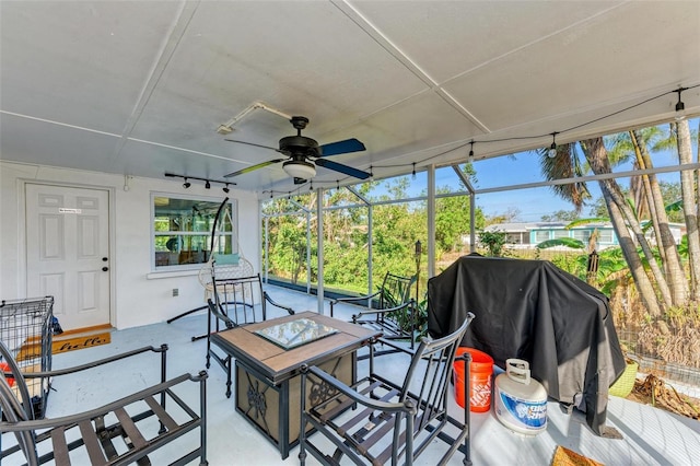 sunroom / solarium featuring ceiling fan and a healthy amount of sunlight