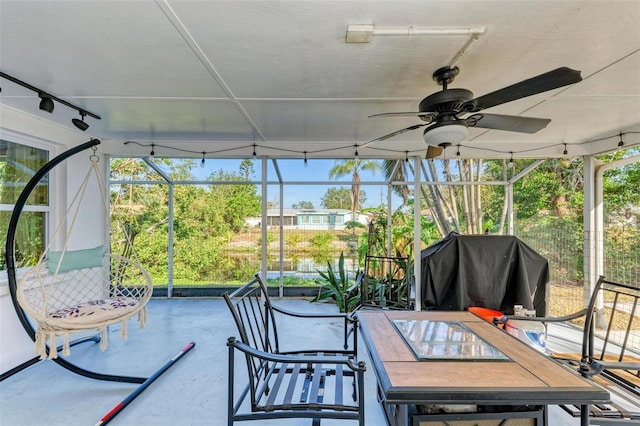 sunroom / solarium with ceiling fan