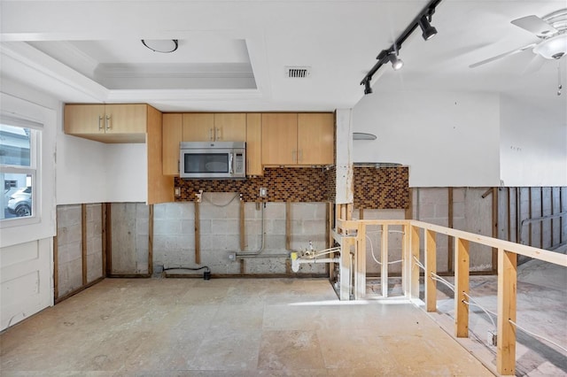 kitchen featuring ceiling fan, light brown cabinetry, and track lighting