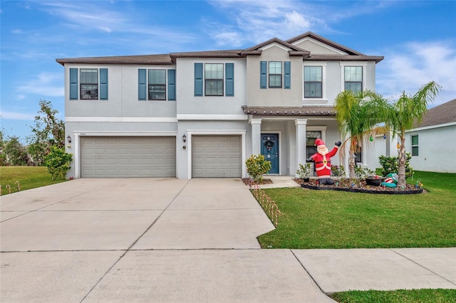 view of front of property with a garage and a front lawn