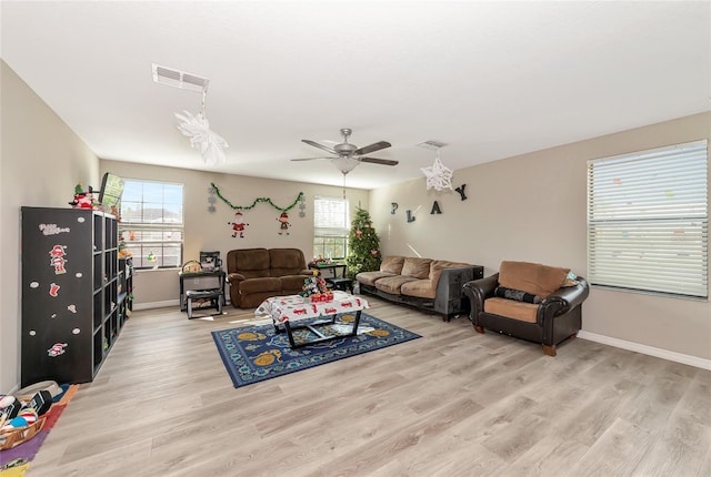 living room featuring light wood-type flooring and ceiling fan