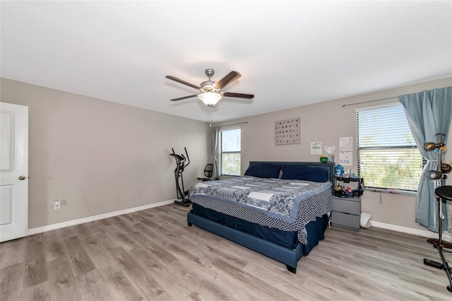 bedroom with ceiling fan and light hardwood / wood-style flooring