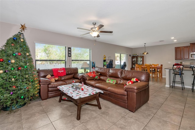 living room featuring ceiling fan and light tile patterned floors