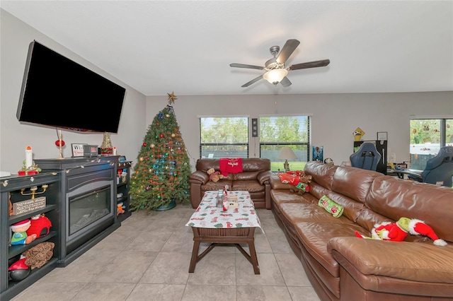 living room with ceiling fan and light tile patterned flooring