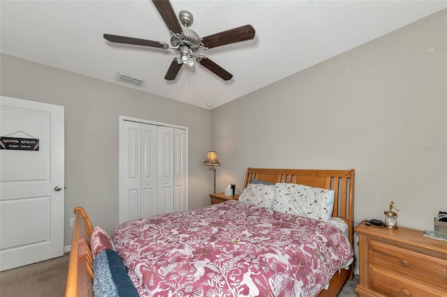 carpeted bedroom with ceiling fan and a closet