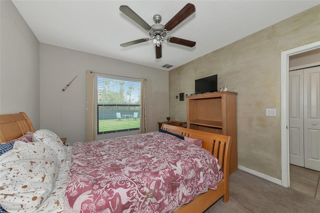 bedroom with light carpet, a closet, and ceiling fan