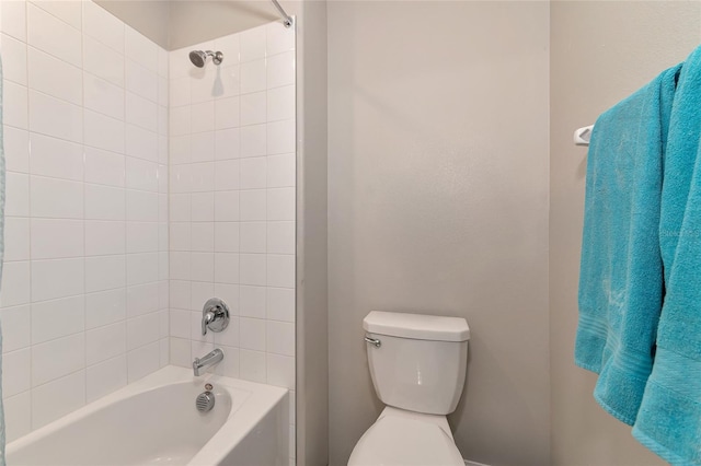 bathroom featuring toilet and tiled shower / bath combo