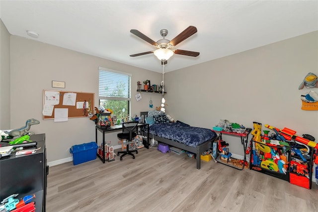 bedroom with ceiling fan and light hardwood / wood-style flooring