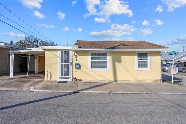 view of front of property featuring a carport