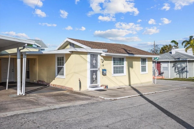 single story home featuring a carport