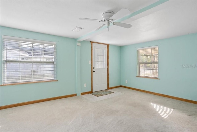 interior space with ceiling fan and light carpet