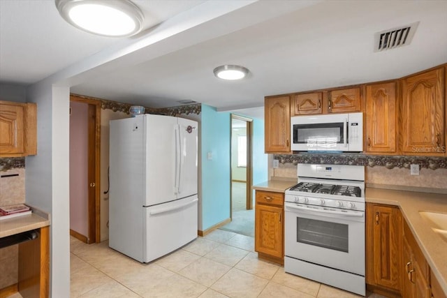 kitchen featuring white appliances and light tile patterned floors