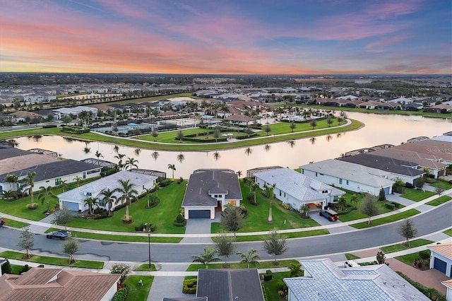 aerial view at dusk with a water view