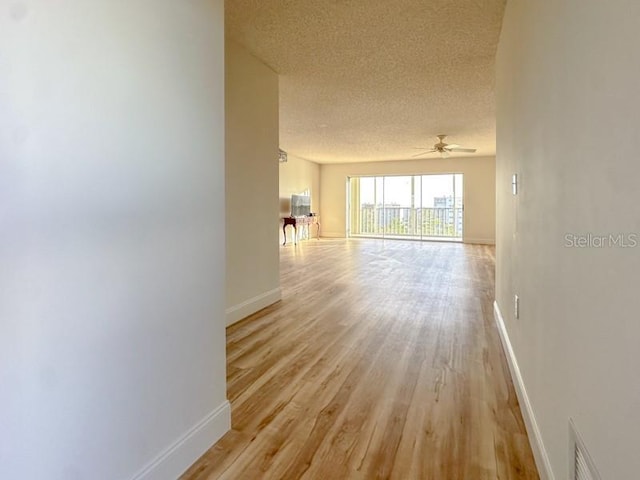 interior space featuring a textured ceiling and light hardwood / wood-style flooring