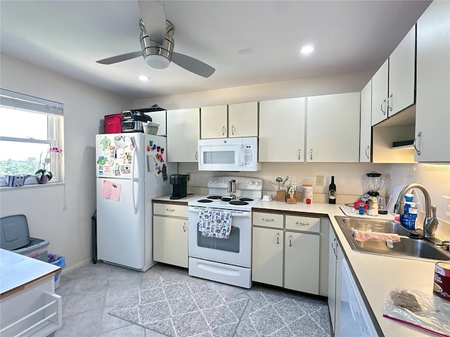 kitchen featuring white cabinetry, sink, ceiling fan, white appliances, and light tile patterned floors