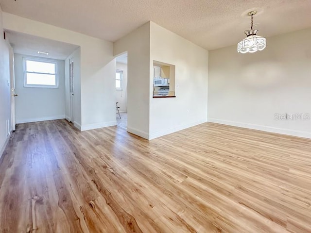 empty room featuring light hardwood / wood-style flooring and a textured ceiling