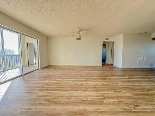 unfurnished room featuring ceiling fan, light hardwood / wood-style floors, and a textured ceiling