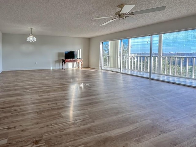 3640 Ironwood Cir Unit 601N, Bradenton, FL 34209 - unfurnished living room with wood finished floors, a textured ceiling, and ceiling fan