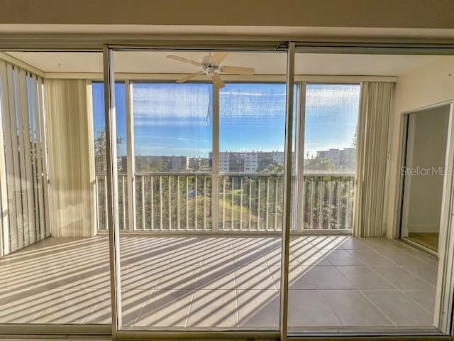 doorway to outside featuring tile patterned floors and ceiling fan