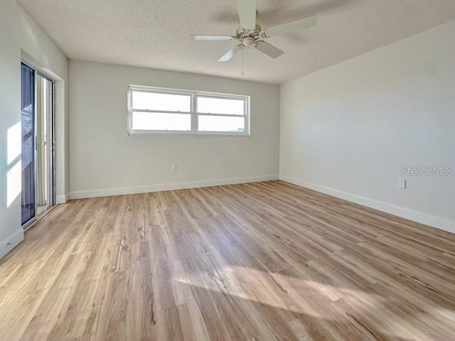 unfurnished room with ceiling fan, light hardwood / wood-style floors, and a textured ceiling