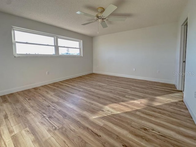 3640 Ironwood Cir Unit 601N, Bradenton, FL 34209 - spare room with wood finished floors, ceiling fan, and a textured ceiling