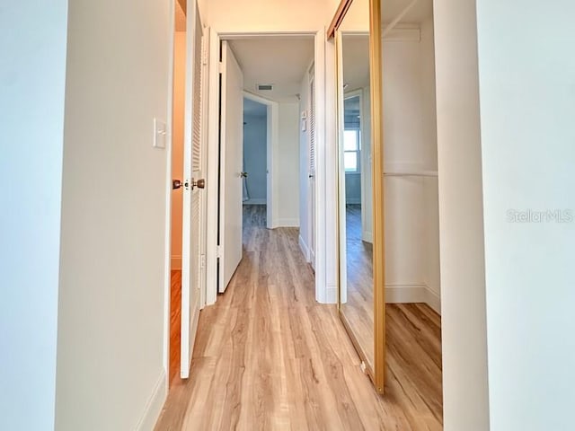 corridor featuring light hardwood / wood-style floors