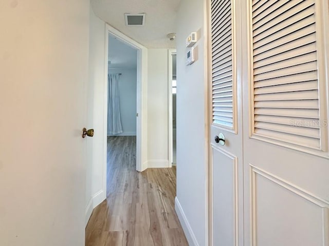 corridor with light wood-type flooring