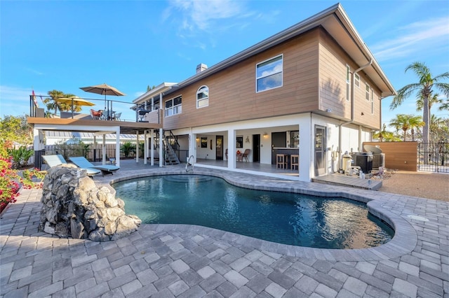 rear view of property with a fenced in pool, outdoor dry bar, a patio area, central AC, and fence